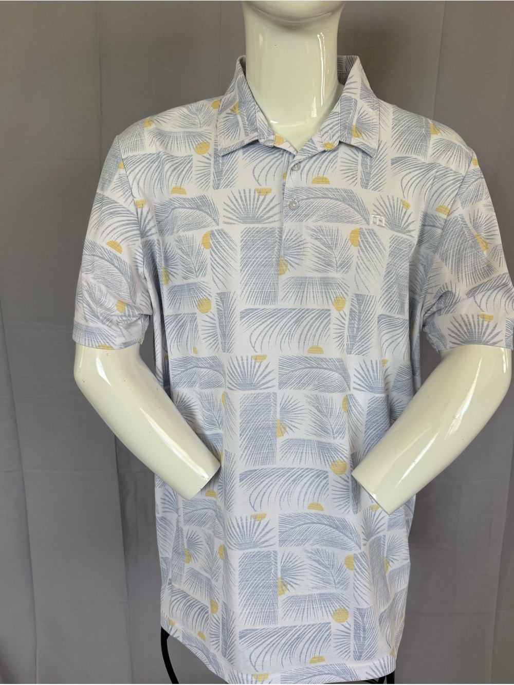 Travis Mathew Light Blue Polo with Yellow Palm Motif